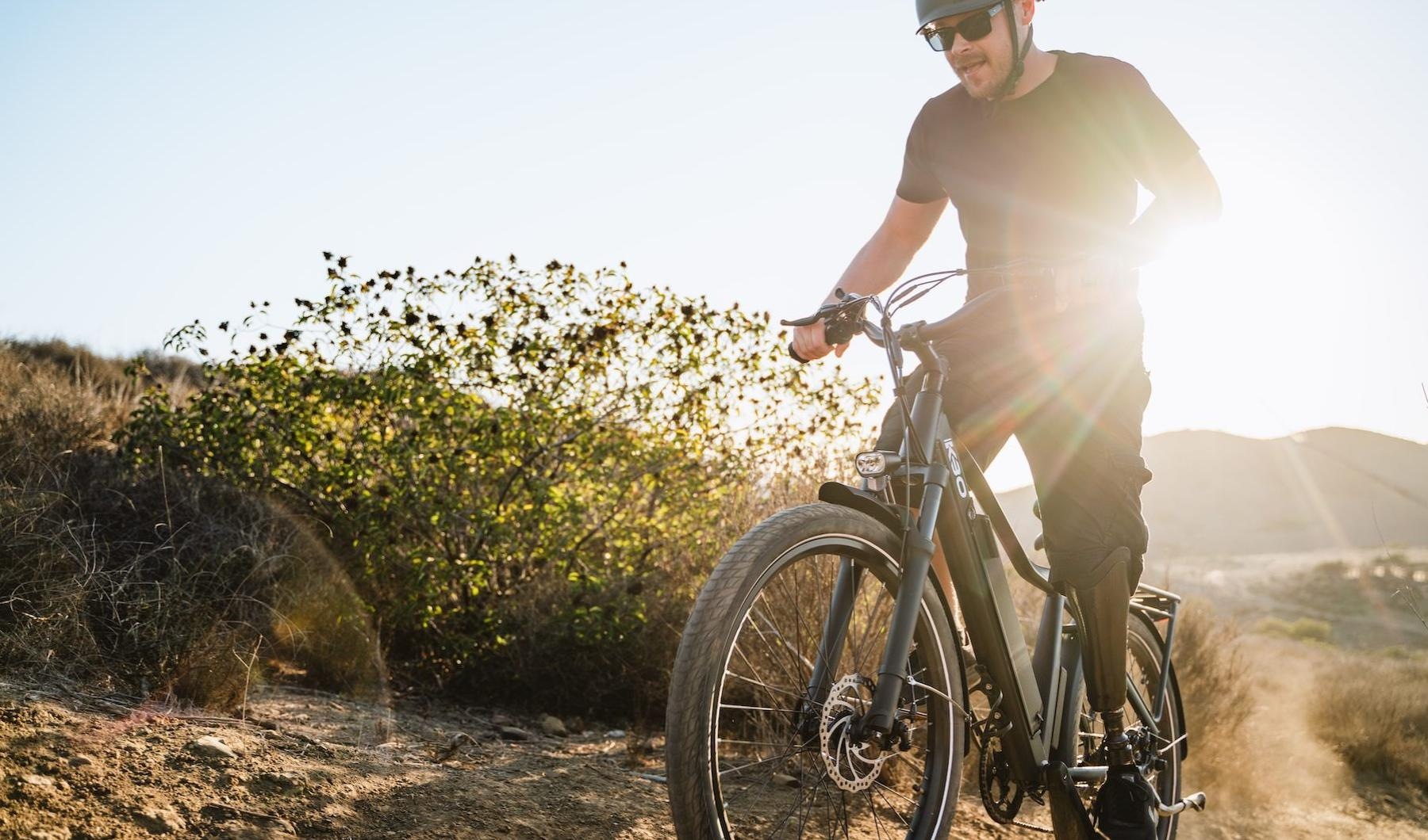 a man riding a bicycle on a hillside