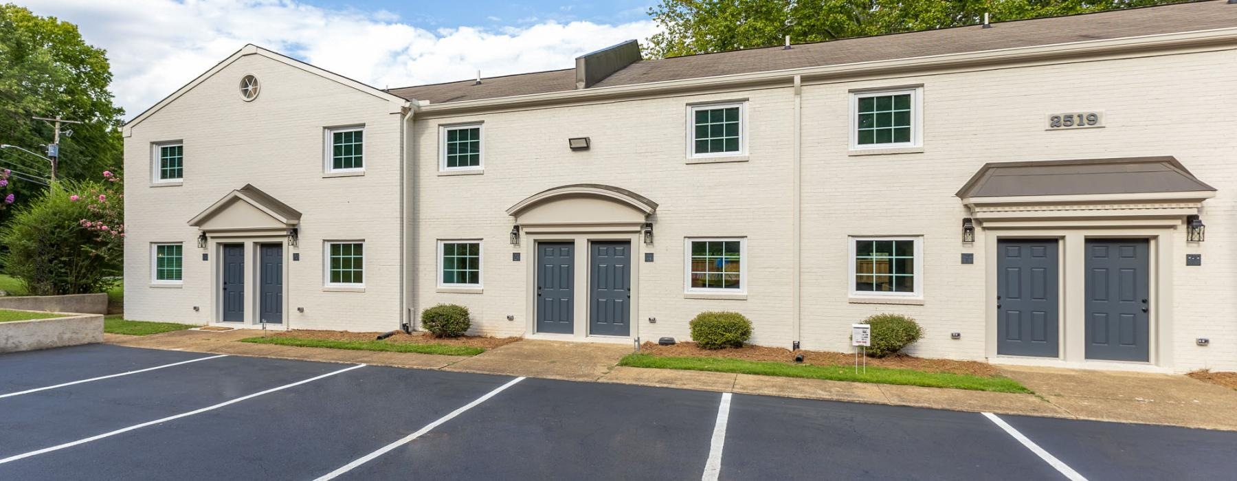 a building with a parking lot in front