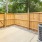 a wooden fence with an air conditioning unit