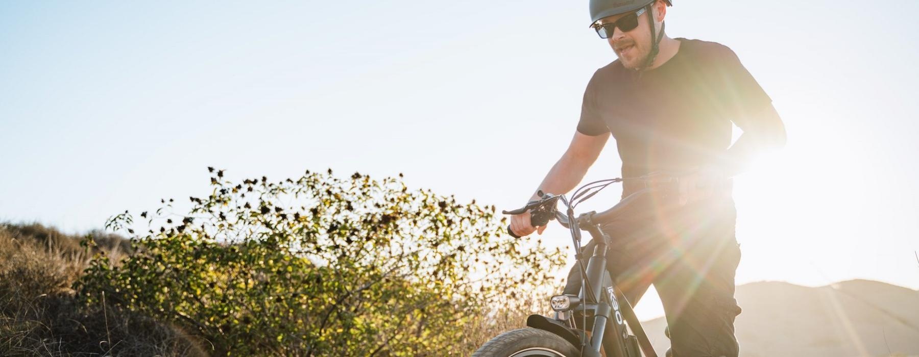 a man riding a bicycle on a hillside